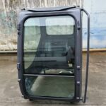 Front view of the Hitachi ZAX70 replacement cab assembly with windscreen, side hinges and mounting feet